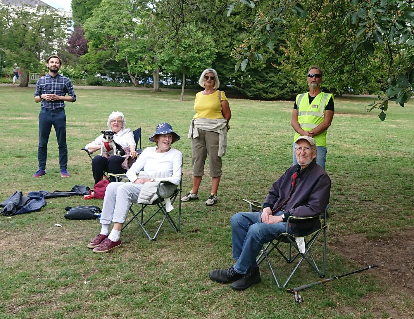 people in a park sat on chairs